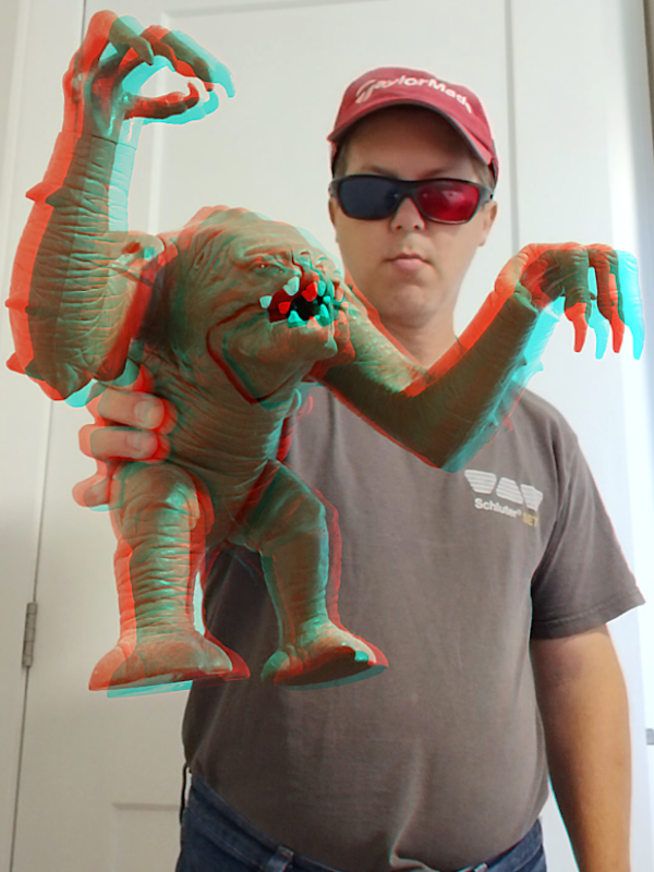Out-of-the-screen depth projection of Rancor toy. Held the Star Wars toy in front of me and converted a pair of photos into red cyan 3D to create the illusion of depth. My hand and the toy appear to contain three-dimensional depth.