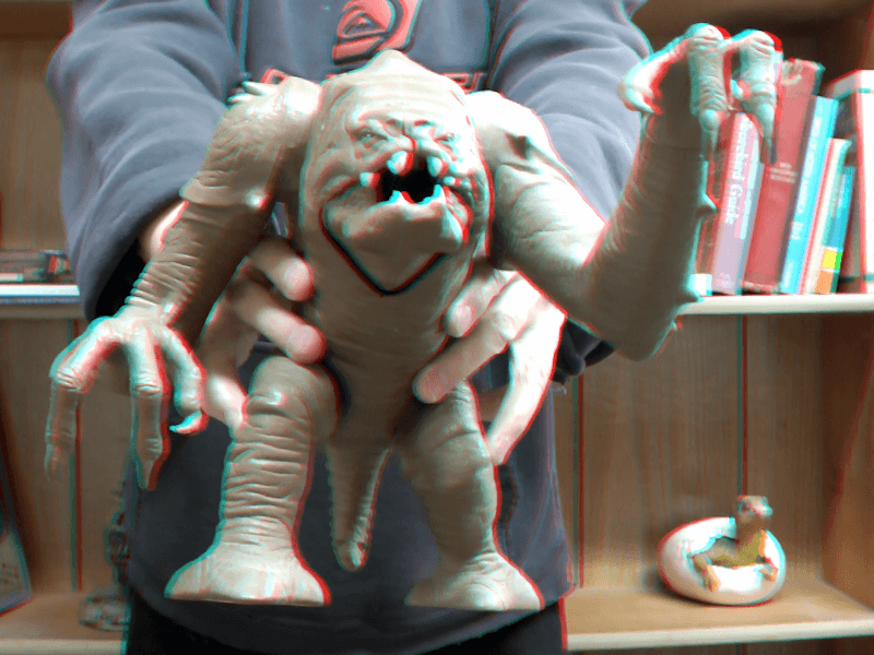 Experimenting with making 3D images. I held out a Star Wars Rancor toy and converted a pair of 2D photos into 3D images.