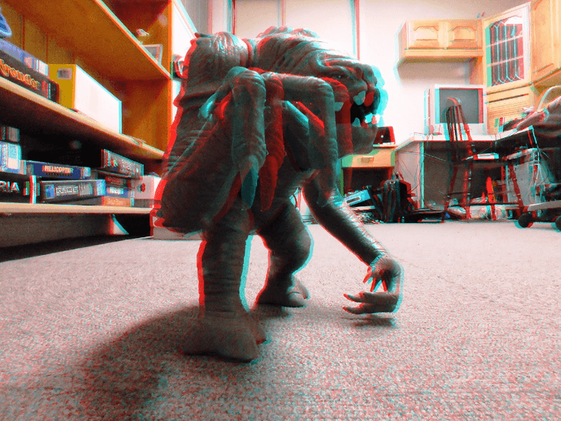 3D image of a Star Wars Rancor toy with an exaggerated pop-out effect. When viewed with red and cyan anaglyph glasses, the arm extends approximately 1.57 inches (4 centimeters) beyond my screen.